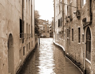 Fototapeta na wymiar narrow navigable canal in Venice in Italy sepia
