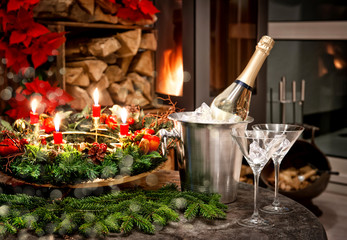 christmas decoration. bottle of champagne, glasses and fireplace