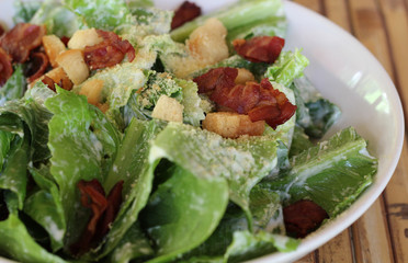 Ceasar salad with lots of dressing and parmesan