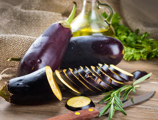 Eggplant and olive oil on a wooden board - 70944646