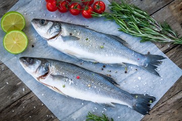 Two raw seabass with lime, cherry tomatoes and rosemary