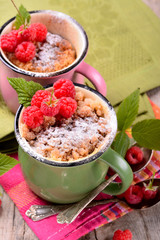 Warm chocolate cake in a mug sprinkled with icing sugar