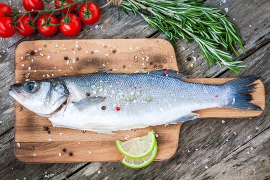 Two raw seabass with lime, cherry tomatoes and rosemary