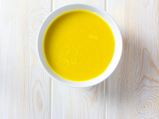 pumkin soup, Top view on wood background