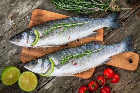 Two raw seabass with lime, cherry tomatoes and rosemary