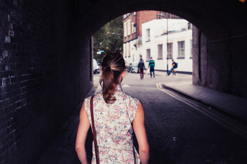 Young woman standing in tunnel