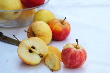 Red apples in white background with knife.