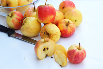 Red apples in white background with knife.