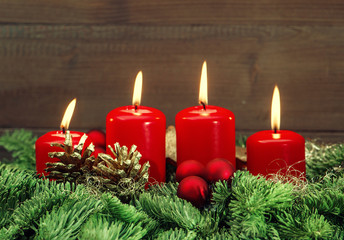 advent decoration with four red burning candles