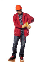 young black construction worker ookingl to his wristwatch