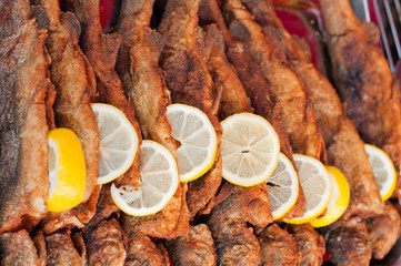 Fresh fried fish with lemon slice. Horizontal image
