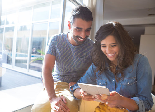 Couple Using Tablet With Sunbeams And Lens Flare