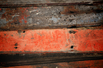 Stack of old red and black wooden board