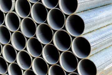 supply of shiny new steel chainlink fence posts