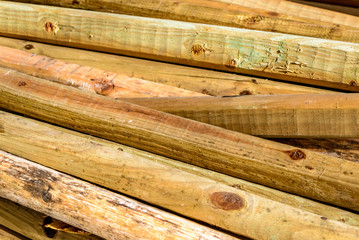 Stacked unpainted wood picket fence lumber