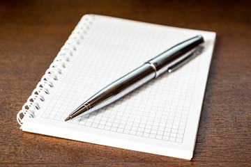 Notebook with a pen on the table