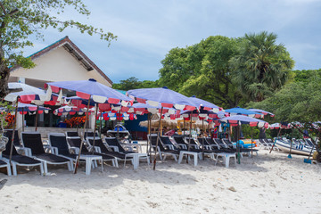 lounge chairs with umbrella on a beach