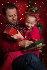 Christmas - smiling father and daughter enjoying gifts