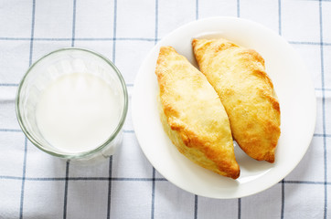 pasties stuffed meat and glass of milk