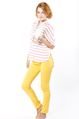 Young slim woman drinks mineral water from a bottle