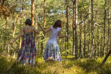 two women walking in the forest