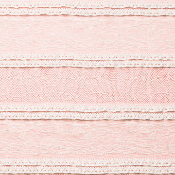 Ivory lace fabric on pink background