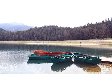 wooden boat on a mooring mountain lake