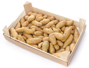 New rattes potatoes in a wooden crate