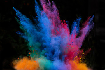 launched colorful powder over black