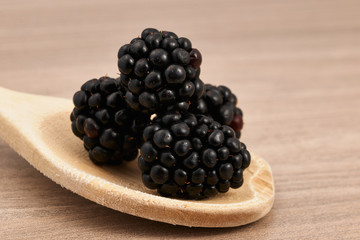 blackberries on a wooden spoon