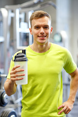 smiling man with protein shake bottle