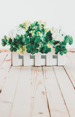 Artificial flowers on a wooden background