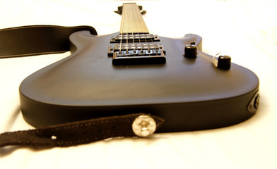 Black electric guitar isolated on the white backgriund