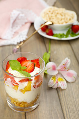 Natural yogurt with fresh berries on wooden table