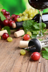 Wine bottle corks with grapes on table close-up