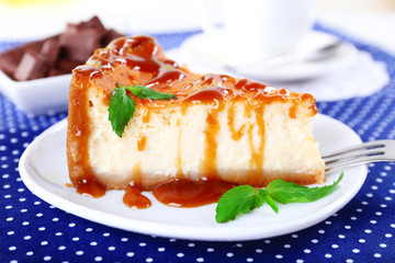 Cheese cake and cup of coffee on polka dot tablecloth