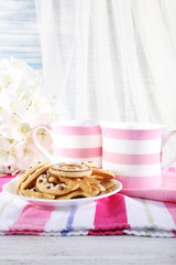 Fototapeta na wymiar Two mugs of coffee with biscuits