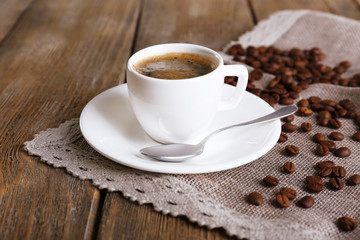 Cup of coffee with milk and coffee beans