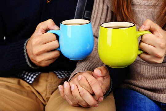 Young couple drinking tea, close-up