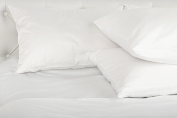 White pillows on bed close up