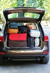 Fototapeta na wymiar Suitcases and bags in trunk of car ready to depart for holidays