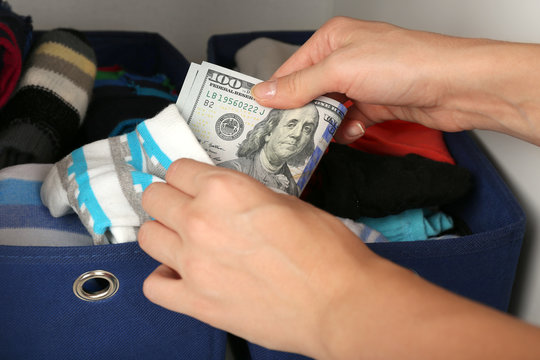 Woman hiding money in sock close up
