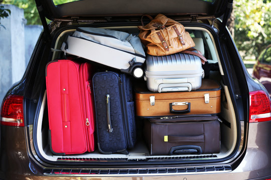 Suitcases and bags in trunk of car ready to depart for holidays