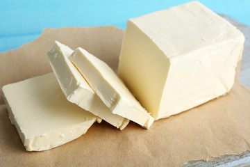 Fresh butter on cutting board, on color wooden background