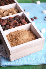 Wooden box with set of coffee and cocoa beans, sugar cubes