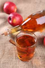 Apple cider with cinnamon sticks and fresh apples