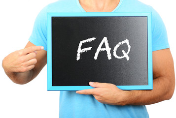 Man holding blackboard in hands and pointing the word FAQ