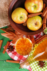 Composition of apple cider with cinnamon sticks, fresh apples