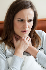 Woman feeling sore throat