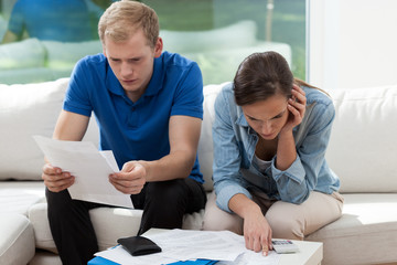 Couple calculating financial budget